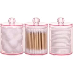 three plastic containers with wooden sticks in them and one container filled with cotton swabs