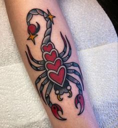 a scorpion with hearts and stars on it's arm