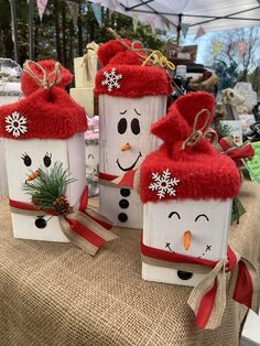 three snowmen made out of toilet paper on top of a table