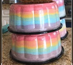 three multicolored dishes stacked on top of each other in front of an oven