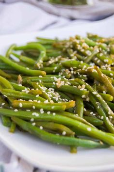 green beans with sesame seeds on a white plate