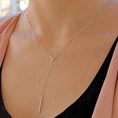 What necklace is perfectly good for V shaped neckline? Necklaces for Your Clothing Neckline V-Neck Tops – You should pair a V-neck top with a V-neck necklace. A rounded necklace looks mismatched if your neckline is plunging, so make sure the chain you wear mimics the cut of the top. • Finish: 925k Sterling Silver • It's dainty and can be worn every day • A special piece you'll treasure • High quality materials and attention to detail • Our jewelry is designed With 🖤️ In NY H O W ∙ T O ∙ O R D E Initial V, Necklace For Neckline, Neck Necklace, V Necklace, Silver Necklace Simple, Tie Necklace, Necklace Long, Silver Gifts, Chic Accessories