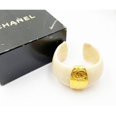 Chanel Super Rare Vintage Gold Plated CC White Stone Cuff Bracelet  *Marked 96 *Made in France *Comes with the original box  -Approximately 2.5″ x 1.5″. -One size fits most. -In a pristine vintage condition.  4916-45375  Please see the measurements section for best approximate dimensions. Designer Cuff Bangle As Gift, Luxury White Cuff Jewelry, Luxury White Cuff Bracelet, Luxury Open Cuff Bracelet, Luxury White Cuff Bracelets, Prada Jewelry, Cartier Ring, Vintage Cartier Bracelet, Dior Ring