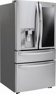 a large silver refrigerator freezer sitting next to a white wall with an ice box on top