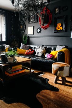 a living room filled with furniture and pictures on the wall