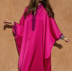 Experience the grace of Moroccan fashion with our Oversized Crepe Kaftan in the charming Pink hue. This kaftan is a masterpiece that seamlessly combines tradition and modernity, offering both style and comfort.   Product Details:      Oversized Crepe Kaftan with Handmade Embroideries : This kaftan is adorned with exquisite handmade embroideries, showcasing the artistry of Moroccan craftsmanship and adding an elegant touch to your look.     Off-White Handmade Embellishments : Delicate off-white h Oversized Elegant Kaftan, Kaftan Dress Modern, Abaya Fashion Dubai, Moroccan Clothing, Modest Casual Outfits, Floral Chiffon Maxi Dress, Kaftan Designs, Mode Kimono, Moroccan Fashion