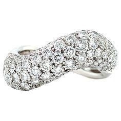 a white gold ring with diamonds on the sides and an intertwined design in the middle