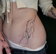 a woman's stomach with a tattoo on it