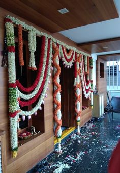 an entrance decorated with flowers and garlands