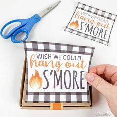 someone is cutting out a card with scissors and some other things to make it look like they are on fire