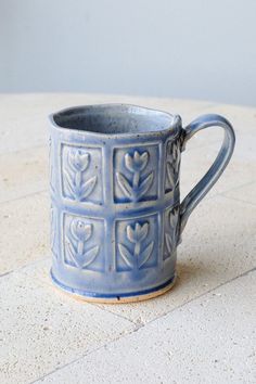 a blue mug sitting on top of a table