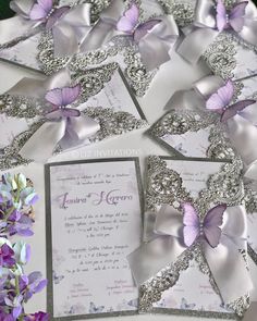 wedding stationery with purple butterflies and silver sequins on the front, lavender flowers in the back