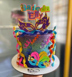 a colorful birthday cake decorated with mardi gras decorations