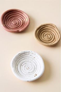 three small bowls sitting next to each other on a table