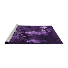 a purple rug on top of a white floor