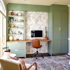 a living room filled with furniture and a flat screen tv on top of a wooden desk