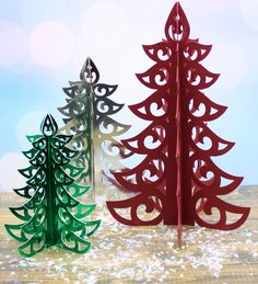 three paper christmas trees sitting next to each other