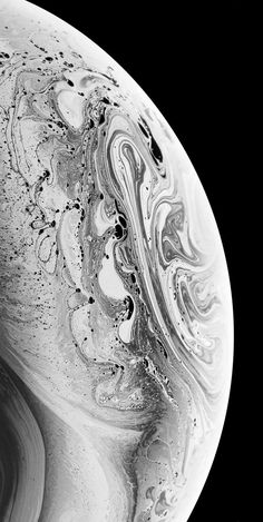 an abstract black and white photograph of the planet saturn