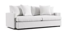 a white couch with four pillows on it's back and one arm facing the camera