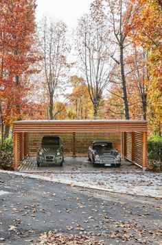 two cars are parked in the parking lot next to each other and covered with wood slats