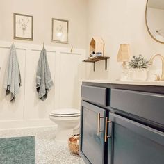 a bathroom with two towels hanging on the wall and a toilet in the corner next to it