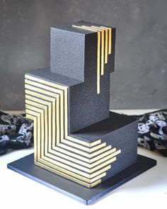 a black and gold sculpture sitting on top of a table