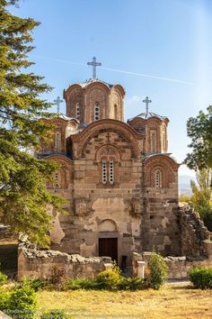 an old church with two towers and crosses on top