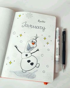 an open notebook with a drawing of a cartoon character on it and a pen next to it