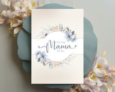 a card with the words to the mama to be on it next to some flowers