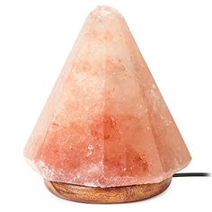 a large pink rock sitting on top of a wooden base