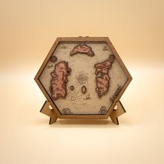 a small wooden box with an image of the island on it's side and two smaller islands in the middle