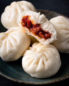 some dumplings are sitting on a blue plate