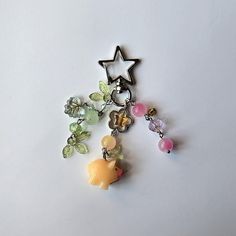 a keychain with charms on it and a star hanging from the end,