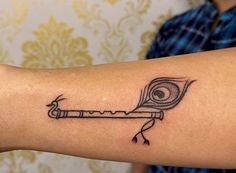 a person with a tattoo on their arm holding a key