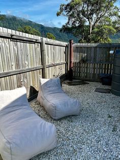 two bean bag chairs sitting on top of gravel