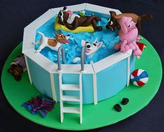 there is a cake that looks like an inflatable pool with dogs on it