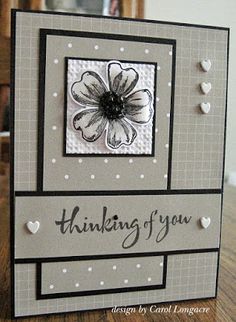 a card with a flower on it and the words thinking of you written in black ink