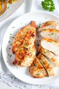 a white plate topped with sliced up chicken