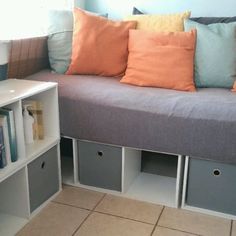 a couch that has some drawers underneath it