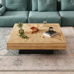 a living room with a couch, coffee table and books on the floor in front of it