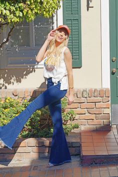 The best looking Bell Bottoms since the 70's! High waisted elastic waist with the perfect amount of stretch! Back pockets for convenience. Fringe bottoms take it to the next level. Believe us you need this. Definitely a wardrobe essential. Model is 5'9 and wearing a small Details Best Seller Fitted High Rise– True To Size 65% Cotton, 33% Polyester and 2% Spandex Machine Wash Cold, Inside Out, Tumble Dry Low Dark Wash Elastic Waistband Stretchy Fabrication Back Pockets Bell Bottom Raw Distressed Casual Flare Bottoms With Elastic Waistband, Retro Mid-rise Pants With Relaxed Fit, Retro Mid-rise Relaxed Fit Pants, Stretch Mid-rise Flare Jeans For Summer, Retro Stretch Bottoms With Pockets, High Rise Bottoms With Elastic Waistband For Day Out, Trendy Flare Bottoms For Day Out, Casual Stretch Flare Jeans For Day Out, Retro Fitted Pants For Day Out