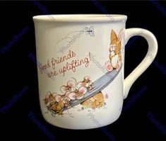 a white coffee mug with an image of a cat holding a knife and flowers on it