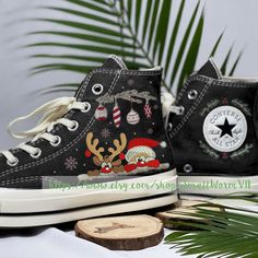 a pair of black sneakers with christmas decorations on them