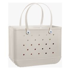 a white tote bag with polka dots on it