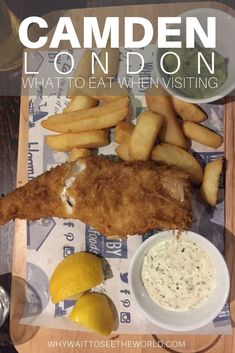 fish and fries on a cutting board with lemon wedges next to it that says camden london what to eat when visiting