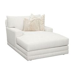 a white chaise lounge chair with two pillows on the back and one arm folded down