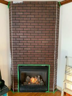 a living room with a fire place in the middle and wood floors on both sides