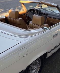 a white convertible car parked on the side of the road