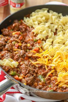 pasta and ground beef in a skillet with cheese on the top, ready to be eaten