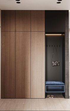 an empty room with wooden cabinets and blue bench